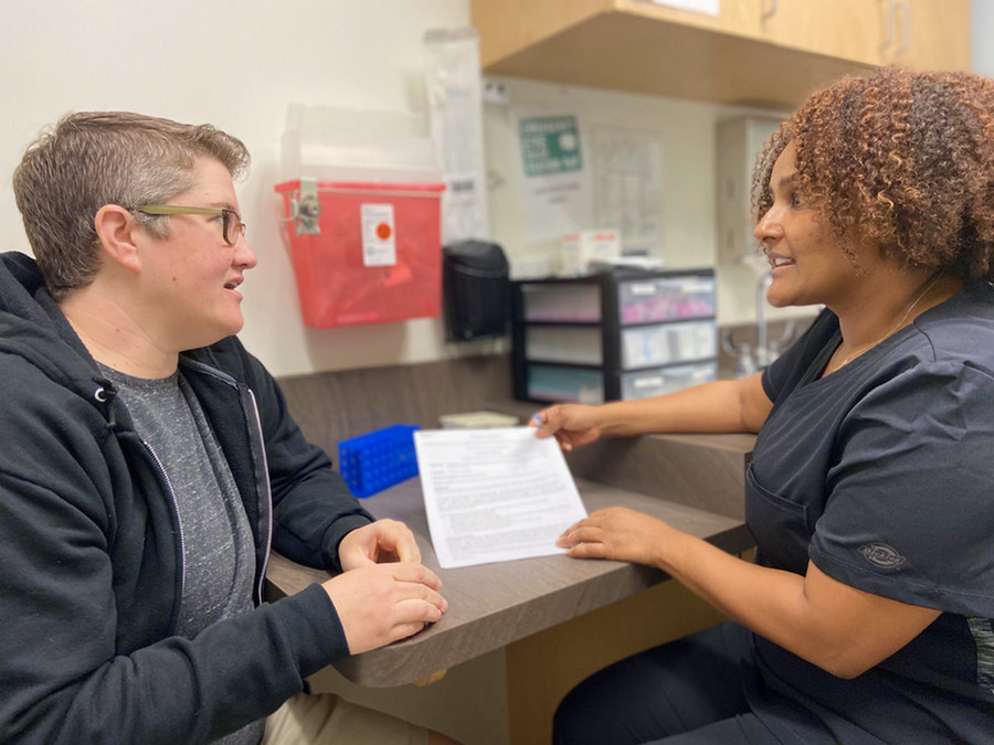Volunteer going over paperwork with a patient